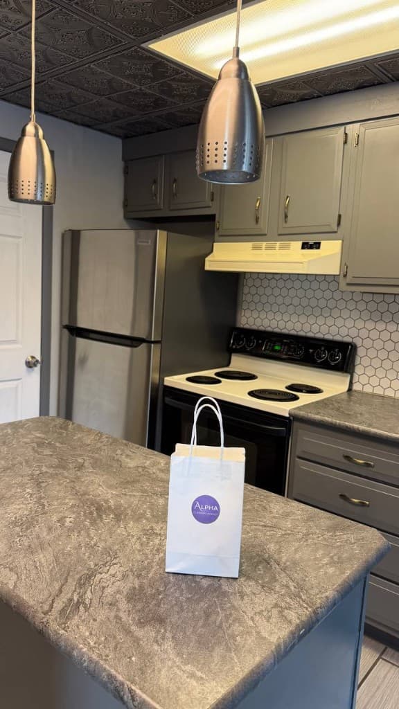 Alpha Cleaning Agency gift bag left on a freshly cleaned kitchen island